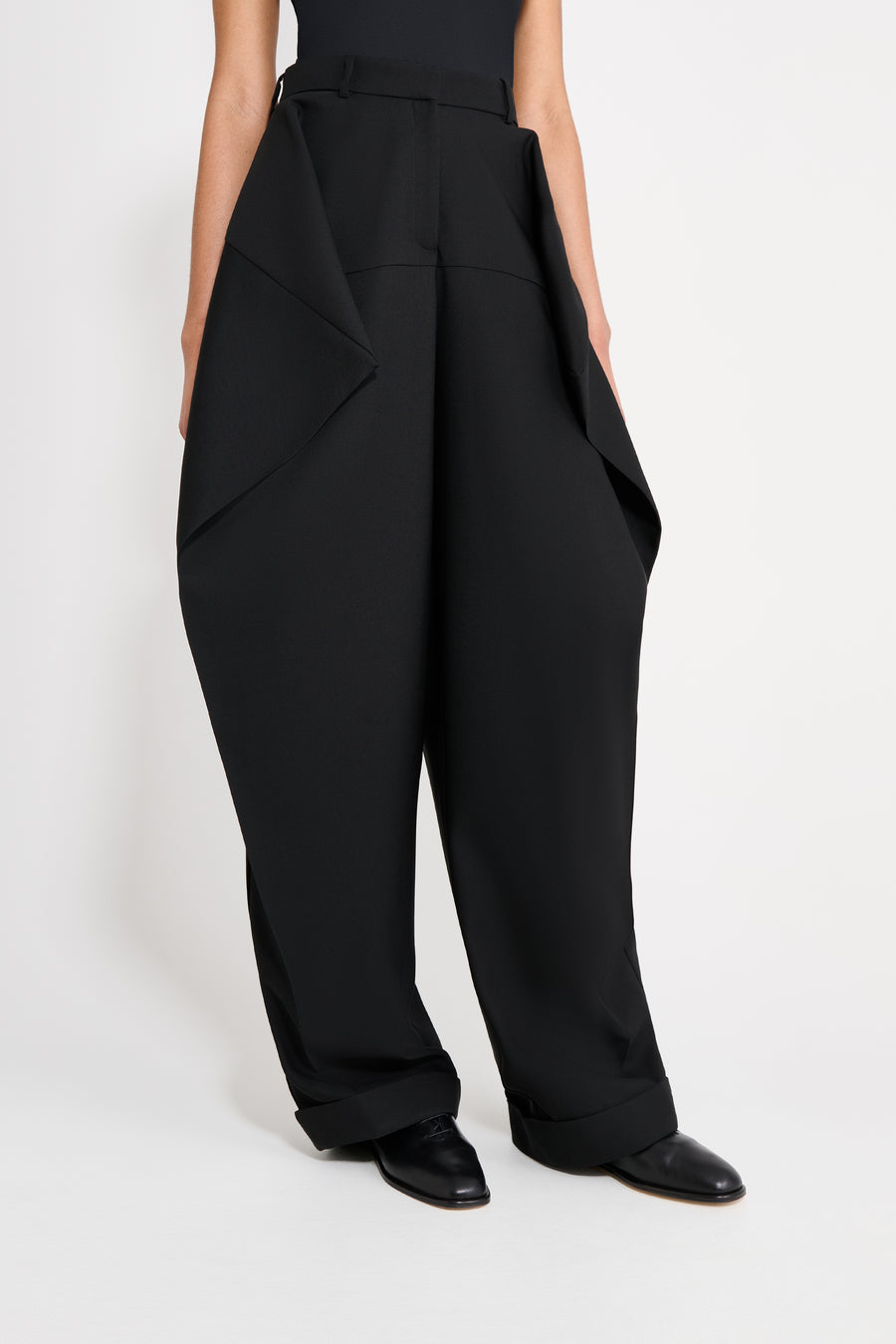 Black wide-leg pants worn by a person on a white background