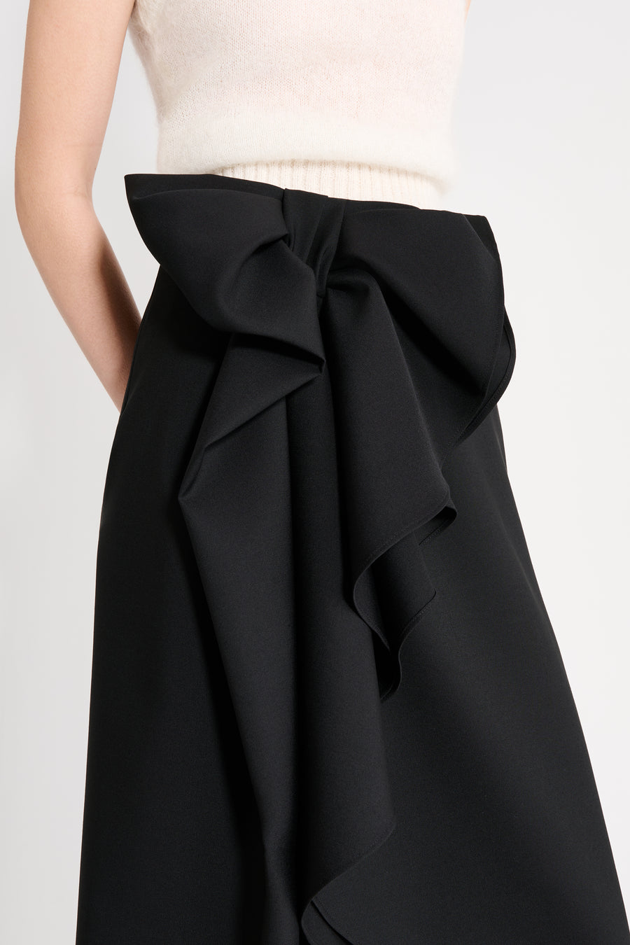Close up on a model wearing a black wool skirt.