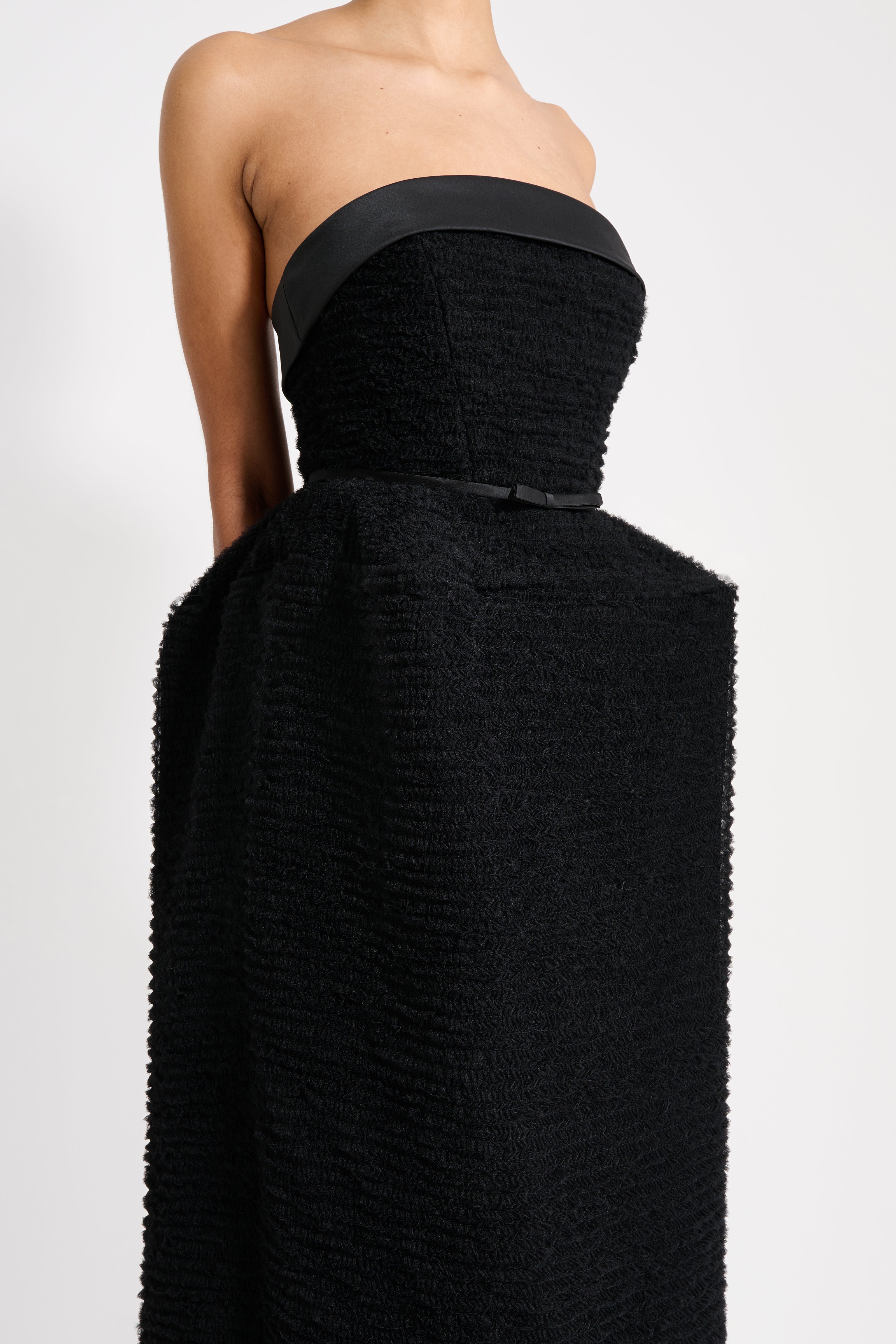 Black strapless dress on a white background