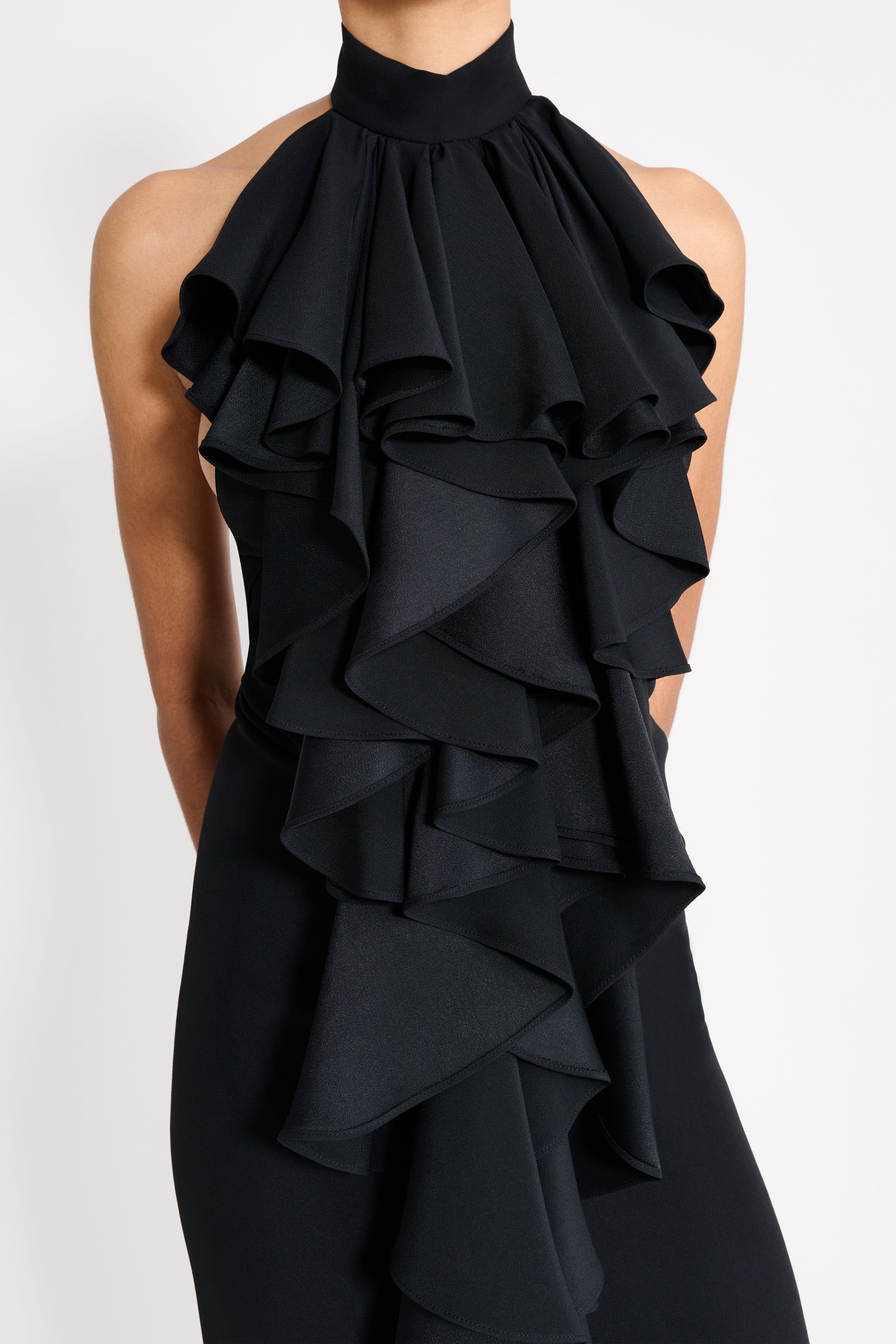 Black ruffled halter dress on a white background