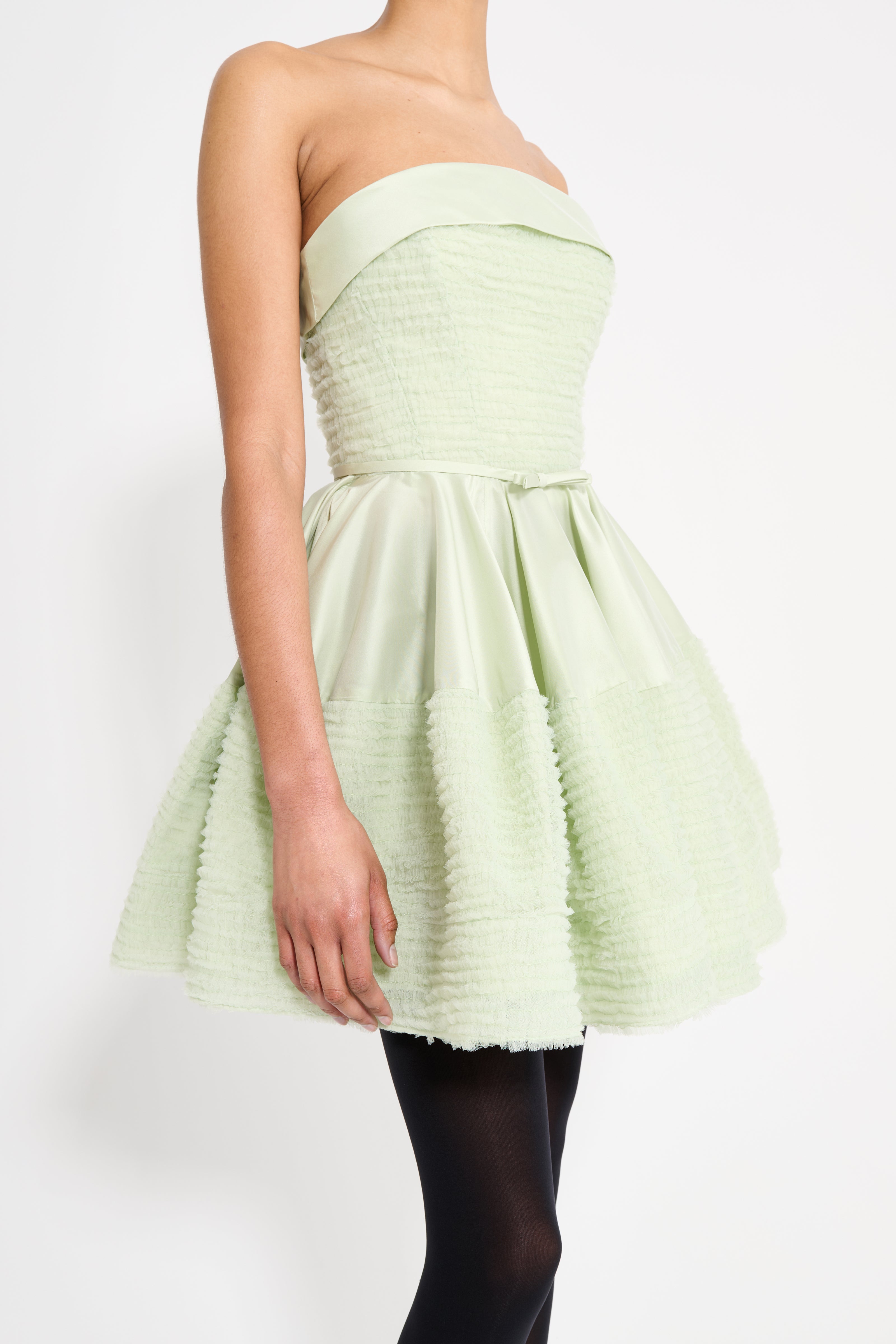 Light green strapless dress on a white background