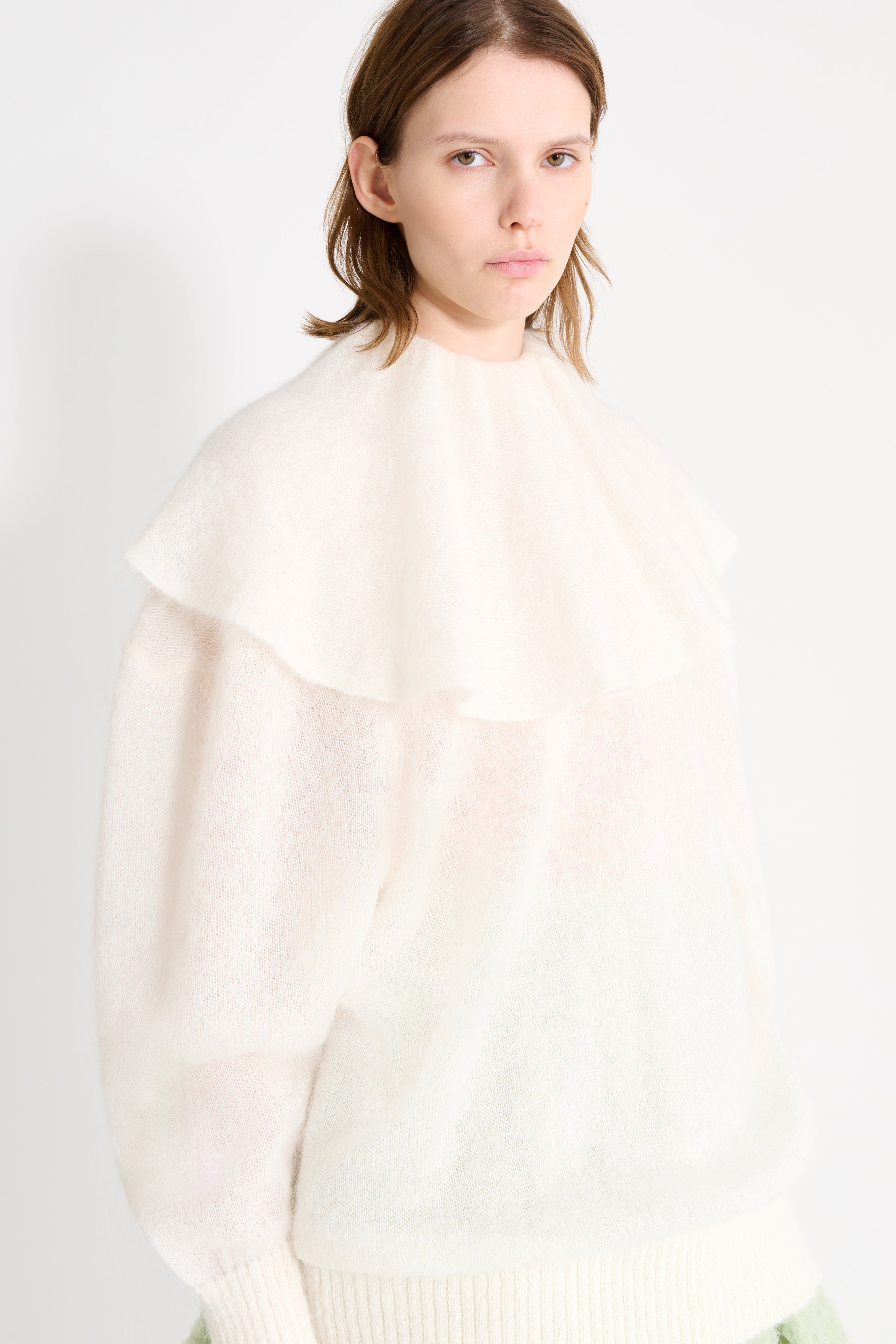 Close up on the volant neck sweater.