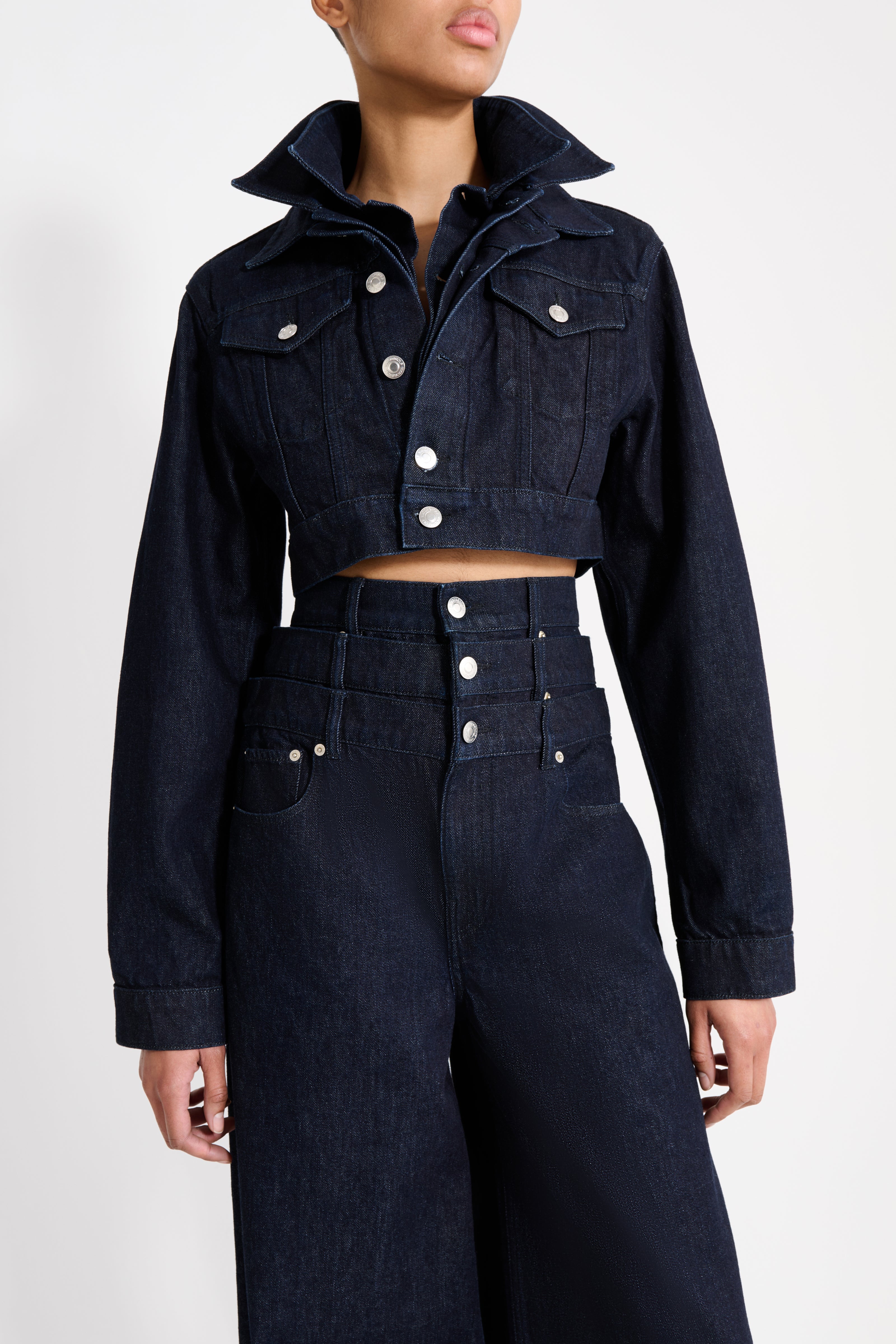 Navy blue denim jacket and pants on a white background