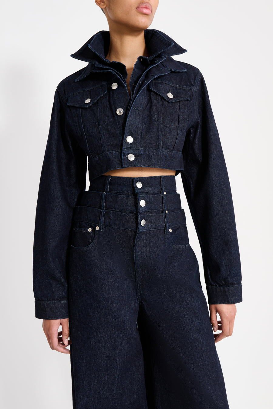 Navy blue denim jacket and pants on a white background