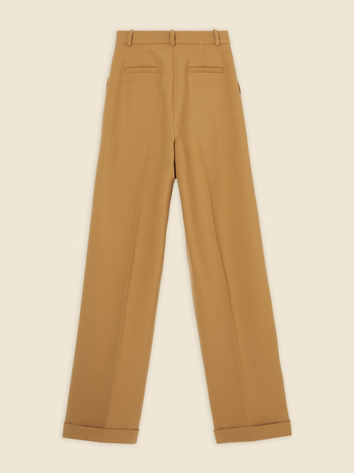 Tailored high-waisted camel wool trousers with welt back pockets and cleanly finished cuffs, exuding classic sophistication.