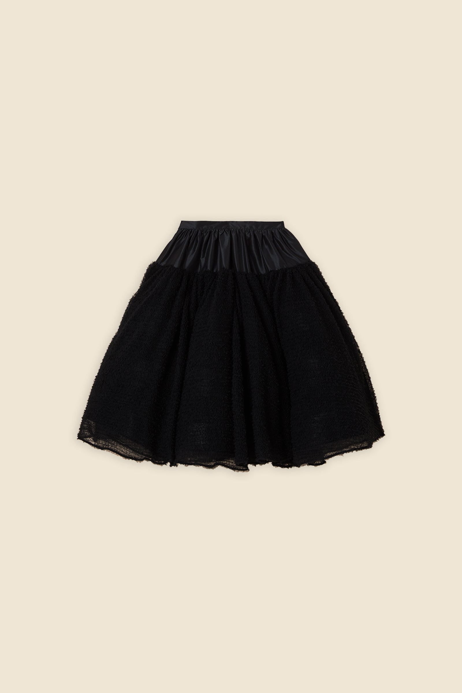 Inspired by the tulle from the ‘late stage capitalism waltz’ haute couture collection, the skirt features hand crafted tulle ruffles for a feminine texture