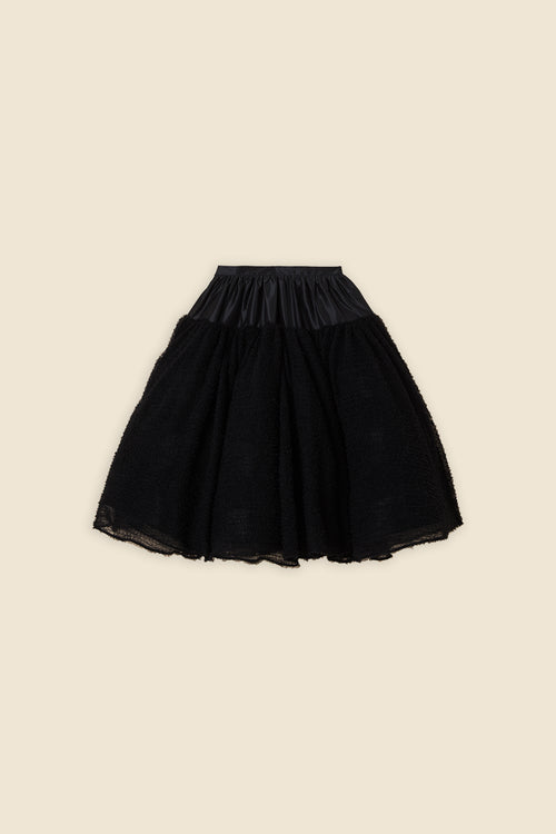 Inspired by the tulle from the ‘late stage capitalism waltz’ haute couture collection, the skirt features hand crafted tulle ruffles for a feminine texture