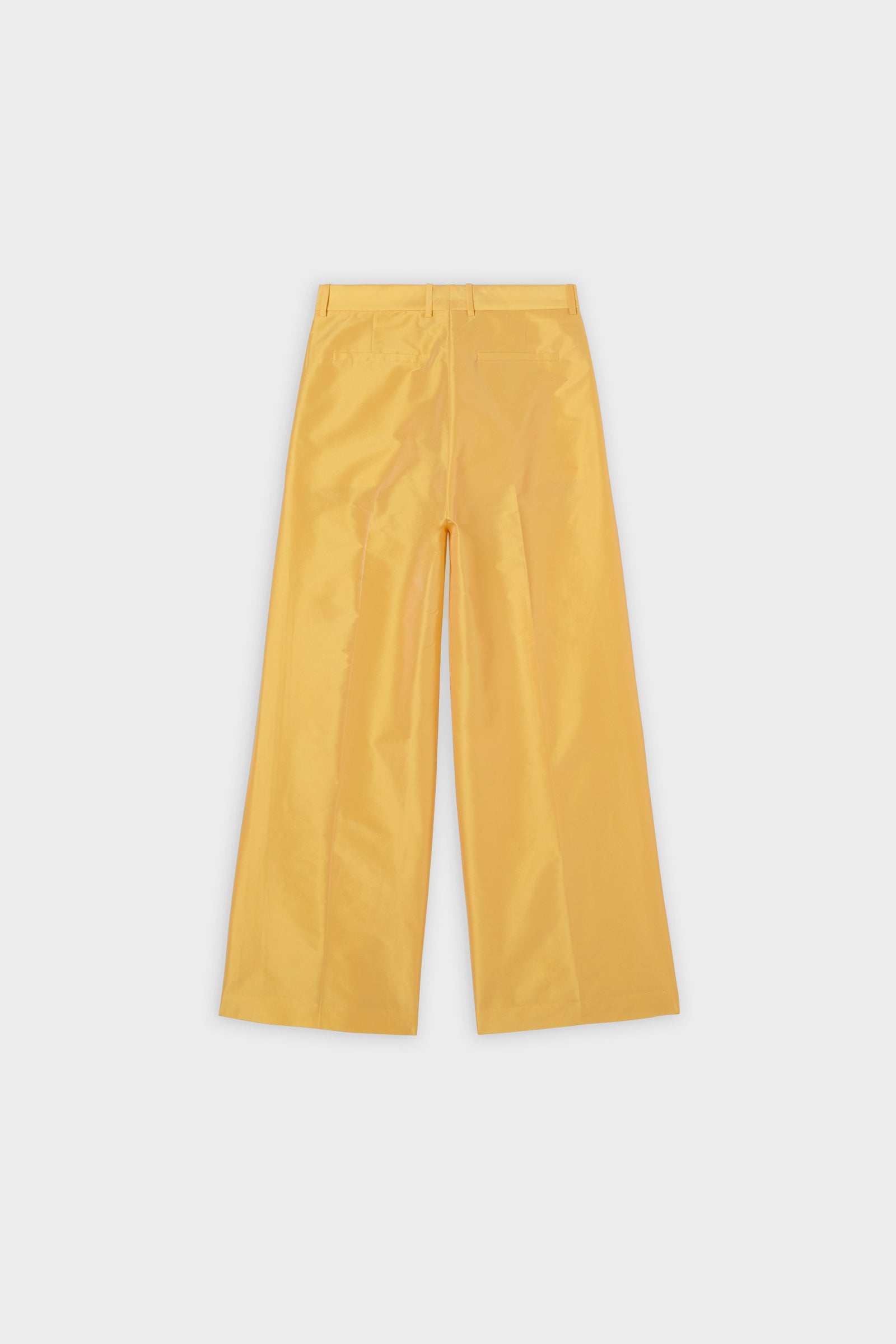 Yellow satin pants on a white background.