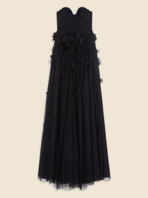 Elegant black evening gown with strapless design and intricate floral details on the bodice and skirt, set on a plain background.