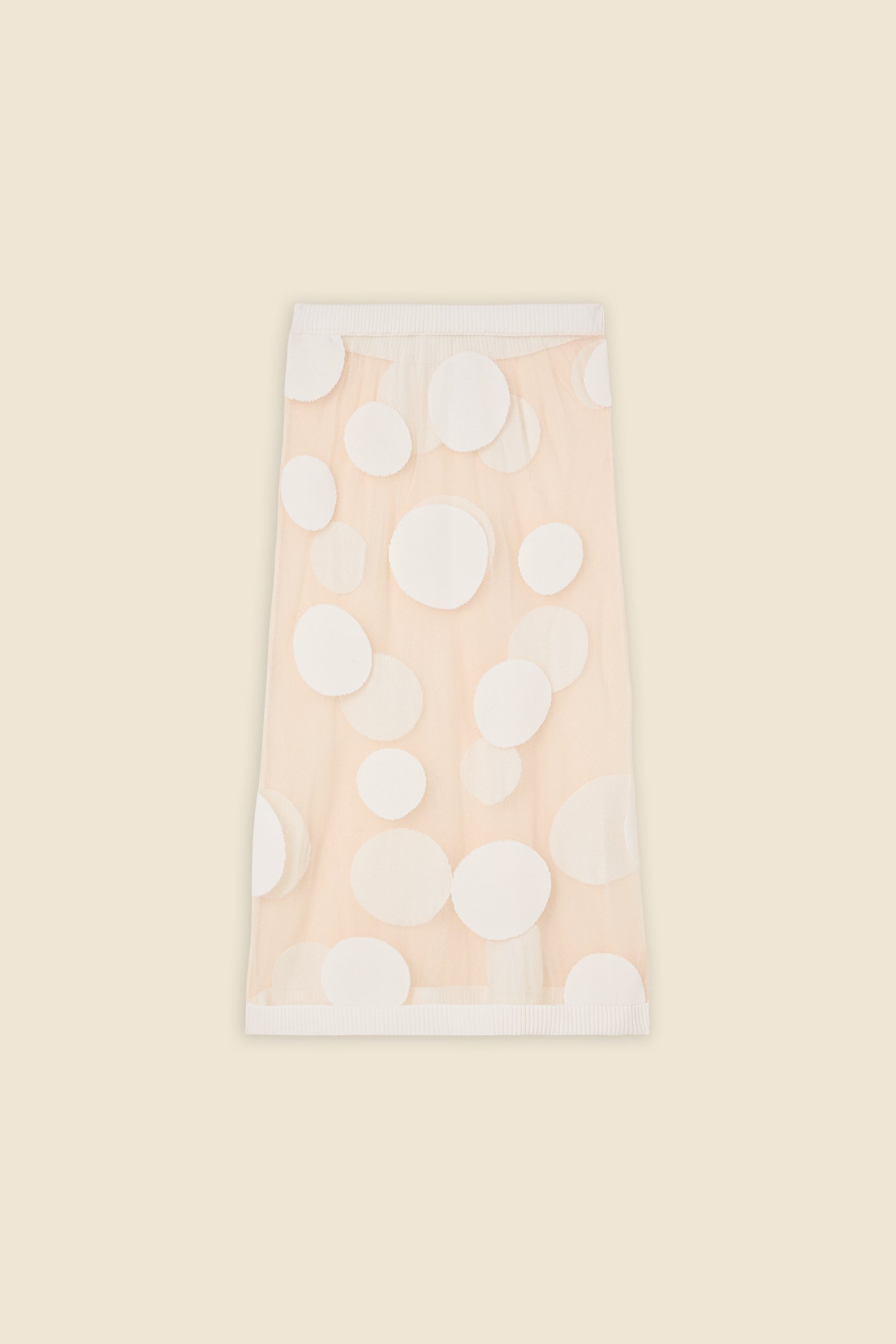 The classic pattern of the skirt is given a modern twist with intricate polka dot hole design on knit jacquard