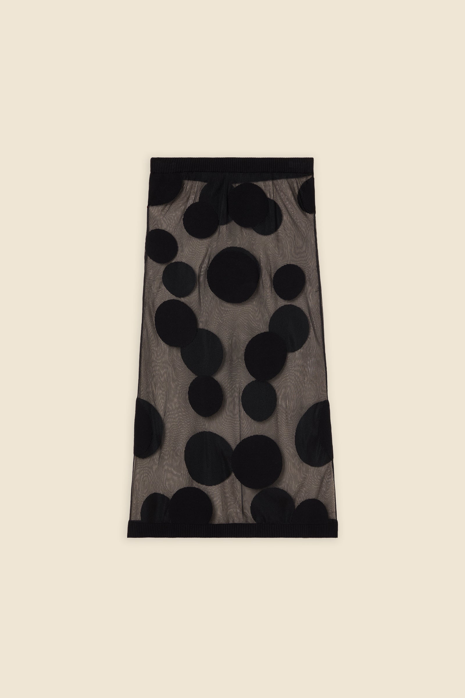 The classic pattern of the skirt is given a modern twist with intricate polka dot hole design on knit jacquard