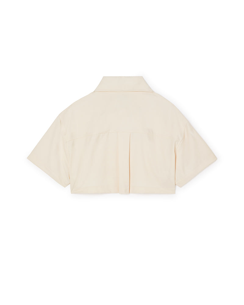 Short-sleeved ivory cotton shirt with a boxy silhouette and back pleat detail, featuring a classic pointed collar.