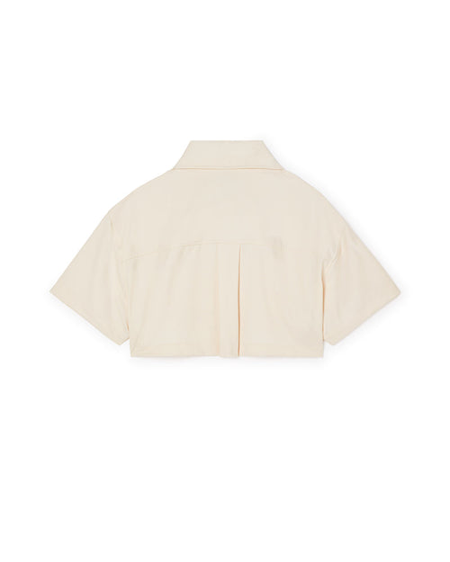 Short-sleeved ivory cotton shirt with a boxy silhouette and back pleat detail, featuring a classic pointed collar.