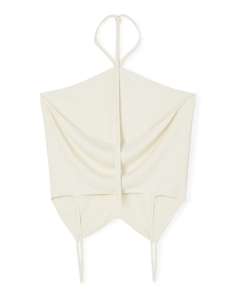 Elegant ivory halterneck top featuring soft draped fabric and designed with minimalist tie straps for contemporary style.
