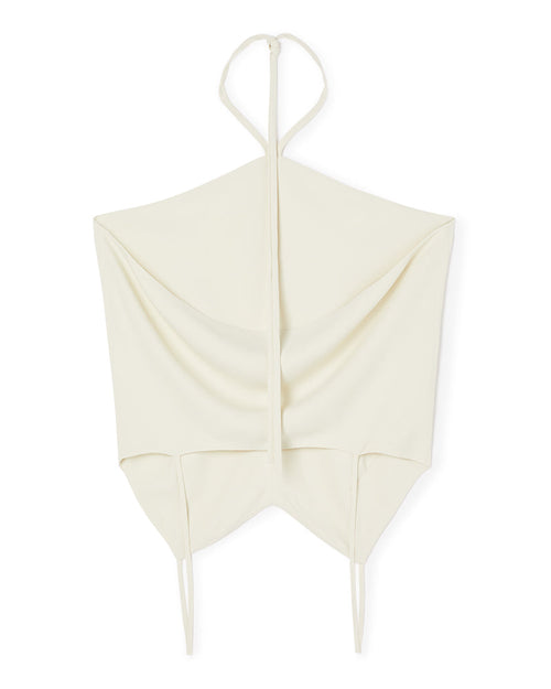 Elegant ivory halterneck top featuring soft draped fabric and designed with minimalist tie straps for contemporary style.