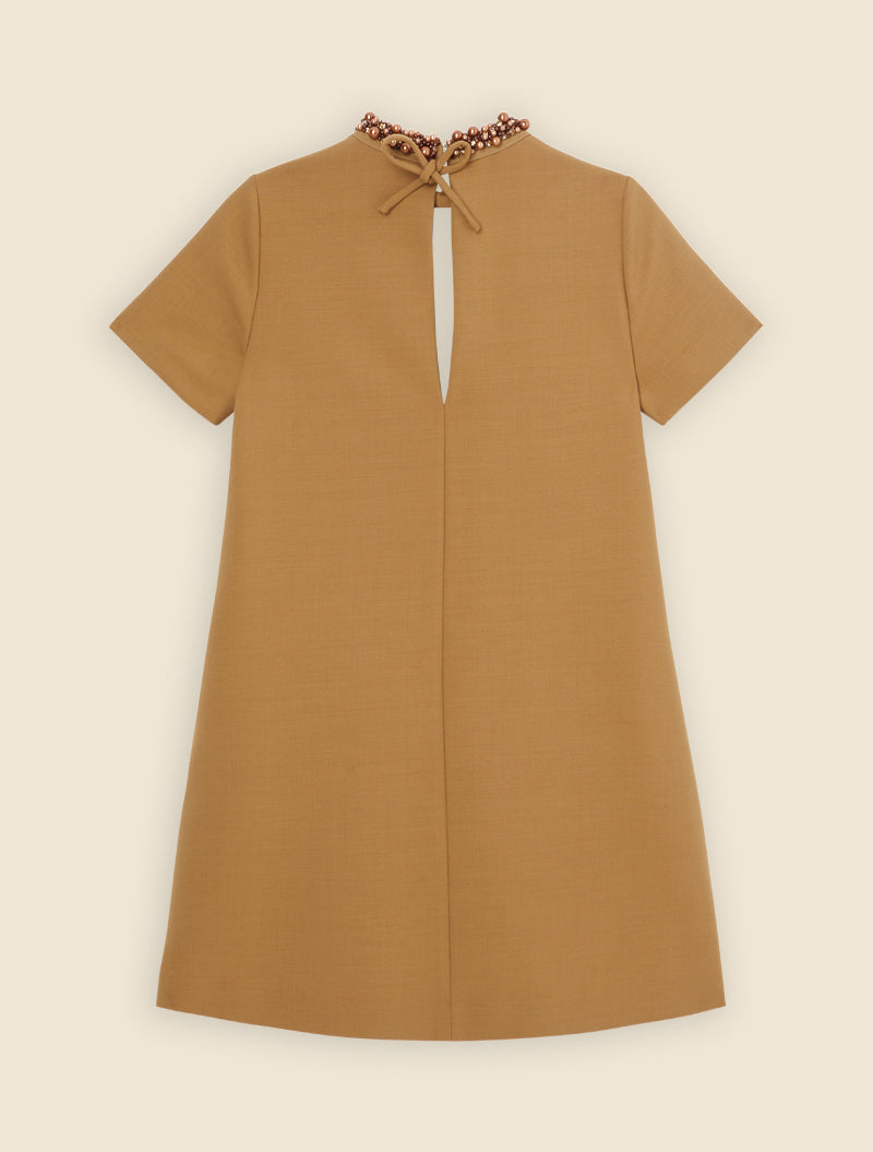 A-line dress in textured camel fabric featuring a pearl-embellished neckline and a graceful back keyhole opening.