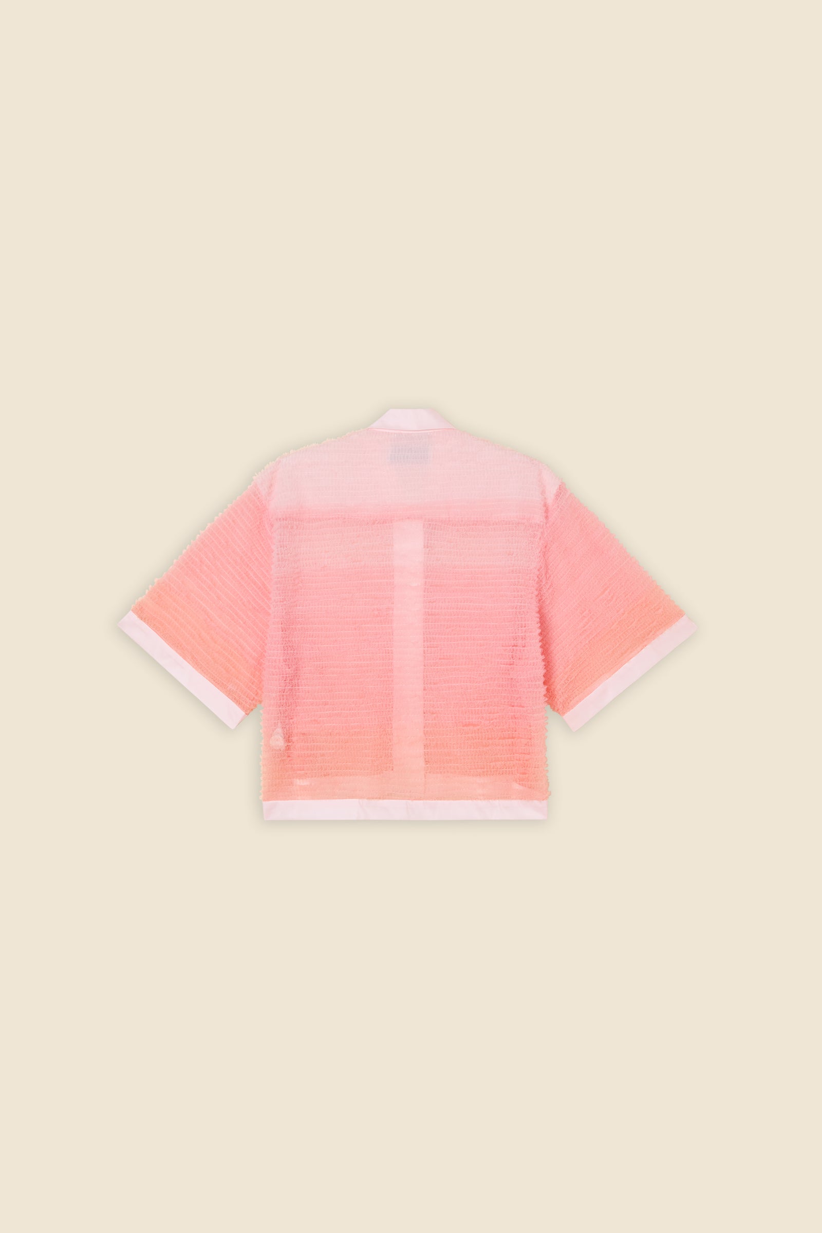 Inspired by the tulle from the ‘late stage capitalism waltz’ haute couture collection, the shirt features hand crafted tulle ruffles for a feminine texture