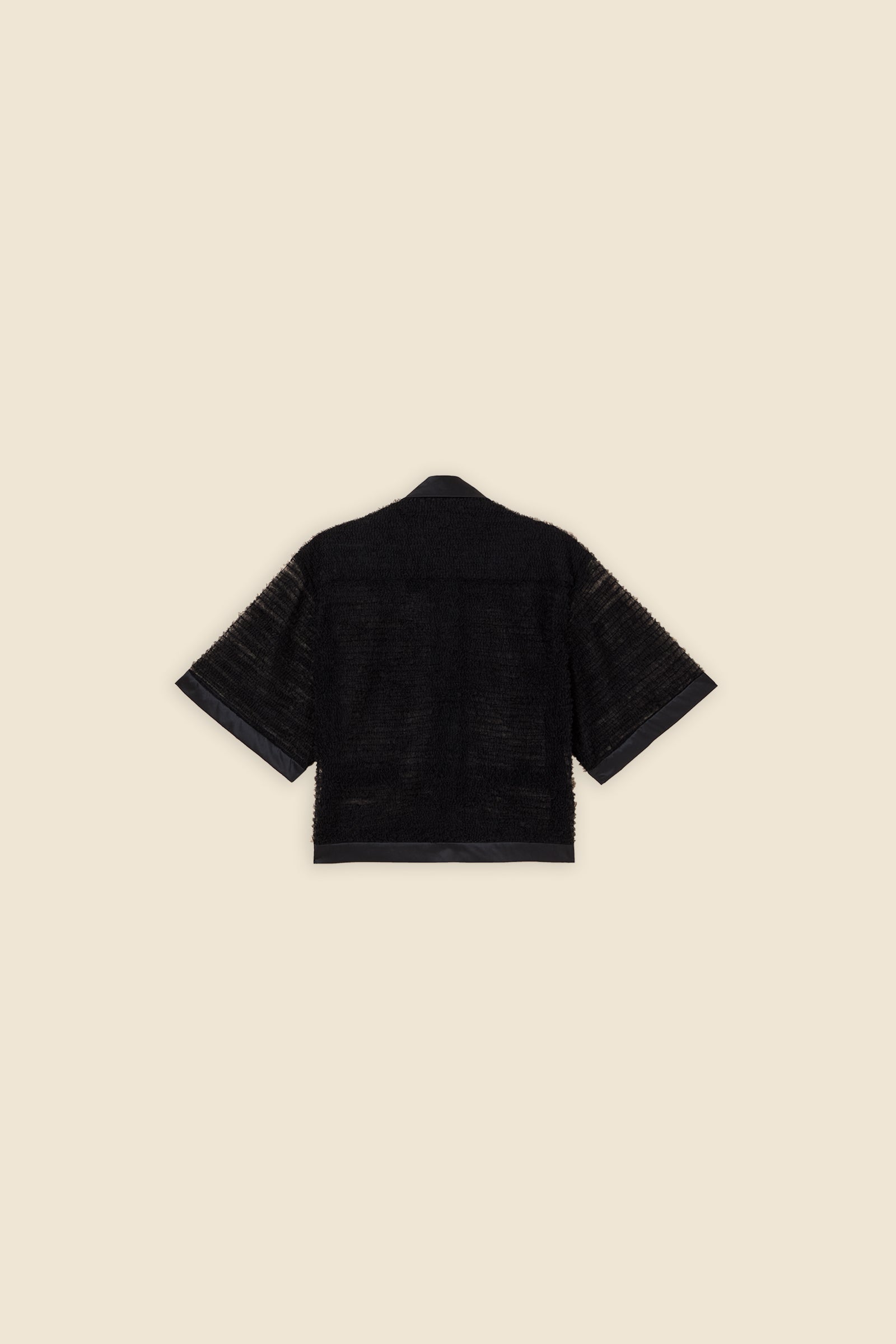 Inspired by the tulle from the ‘late stage capitalism waltz’ haute couture collection, the shirt features hand crafted tulle ruffles for a feminine texture