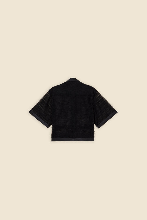 Inspired by the tulle from the ‘late stage capitalism waltz’ haute couture collection, the shirt features hand crafted tulle ruffles for a feminine texture