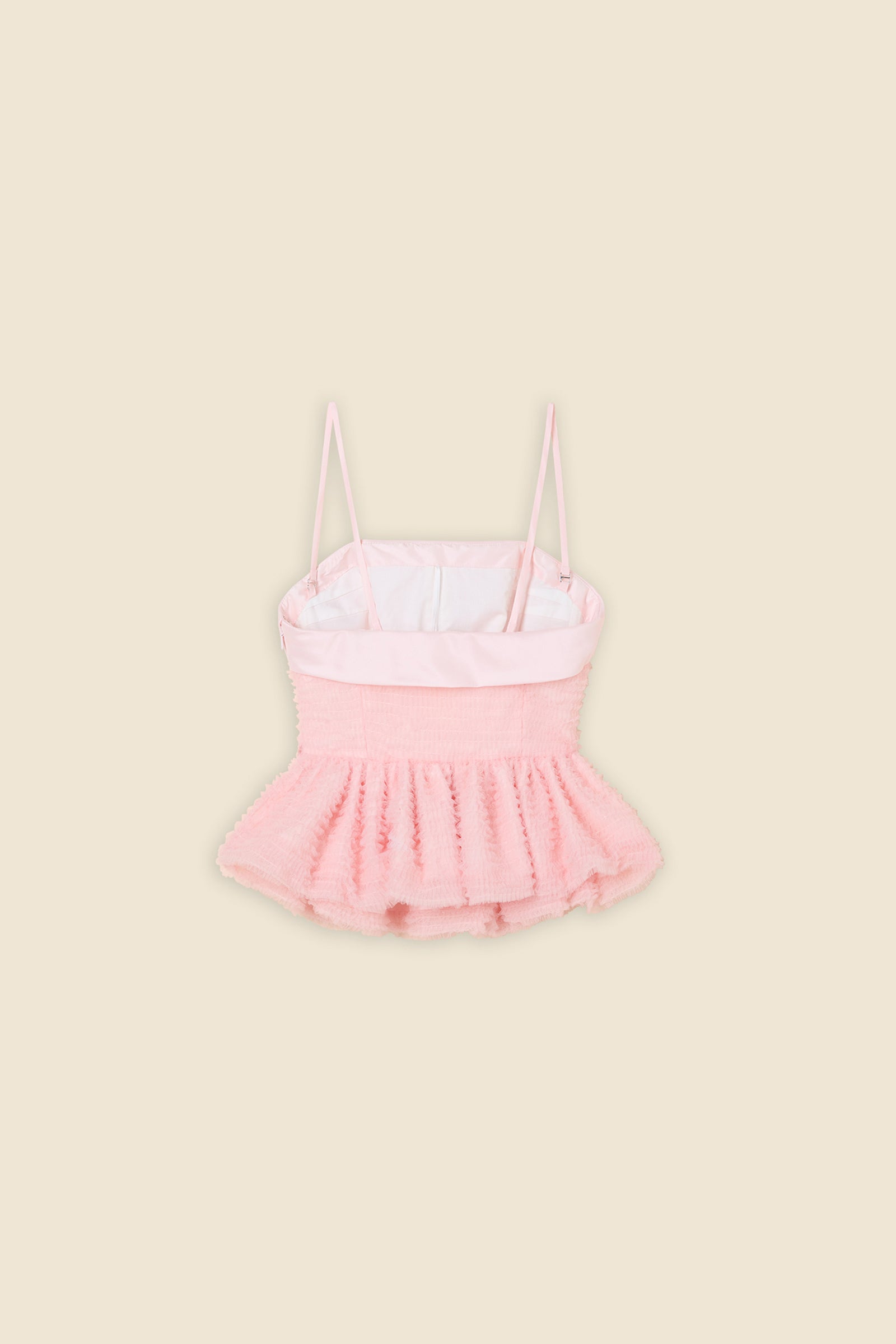 Inspired by the tulle from the ‘late stage capitalism waltz’ haute couture collection, the top features hand crafted tulle ruffles for a feminine texture