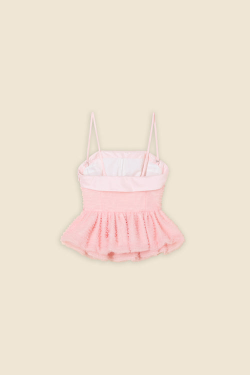 Inspired by the tulle from the ‘late stage capitalism waltz’ haute couture collection, the top features hand crafted tulle ruffles for a feminine texture