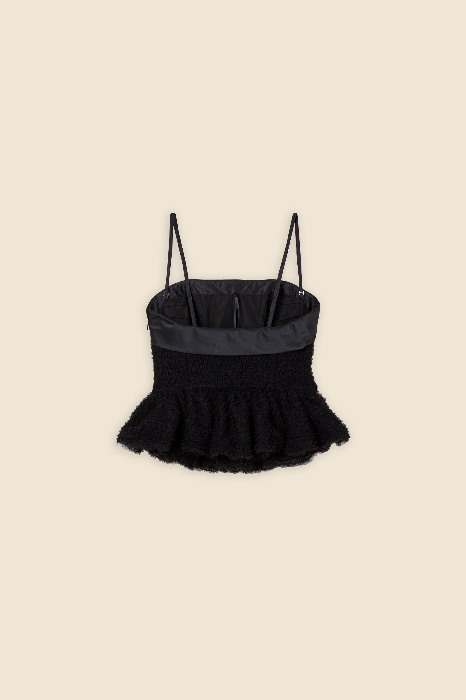 Inspired by the tulle from the ‘late stage capitalism waltz’ haute couture collection, the top features hand crafted tulle ruffles for a feminine texture