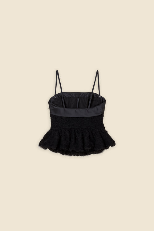 Inspired by the tulle from the ‘late stage capitalism waltz’ haute couture collection, the top features hand crafted tulle ruffles for a feminine texture