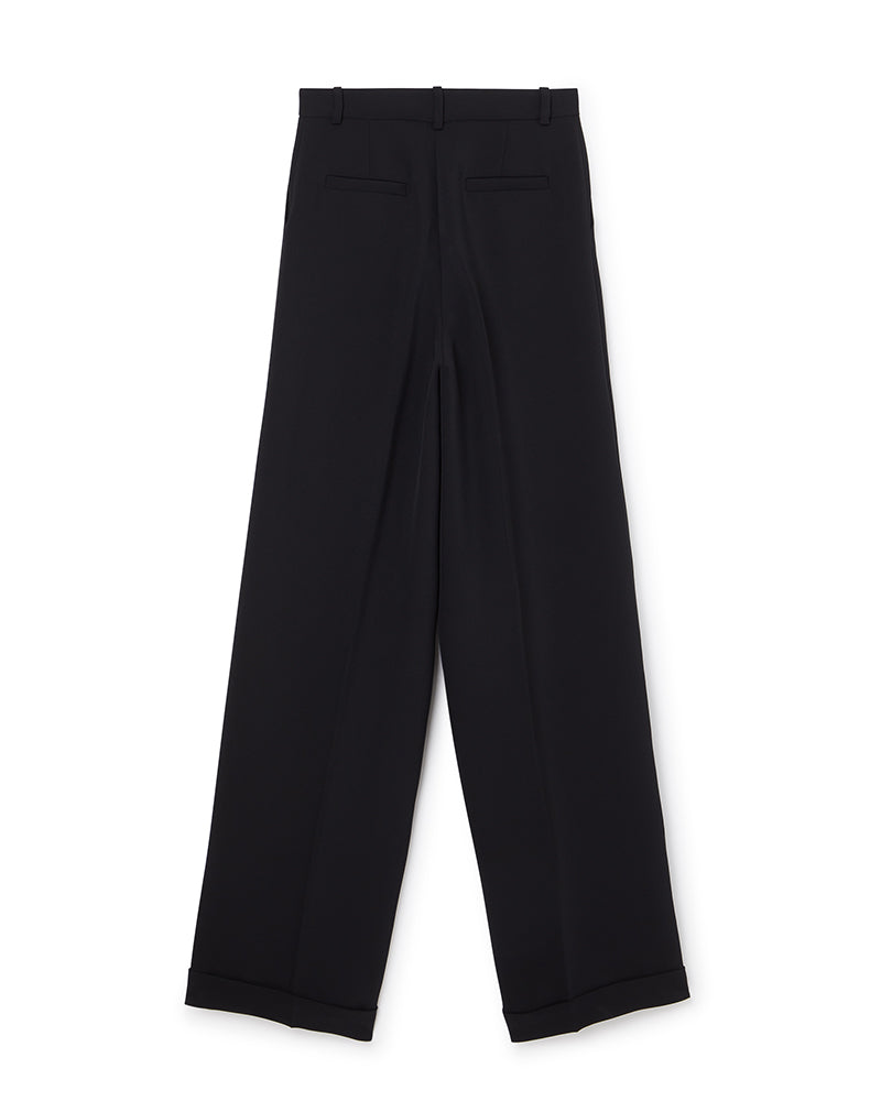 Wide-leg black tailored trousers with crisp pleats and cuffed hems, featuring belt loops and sleek back pockets.