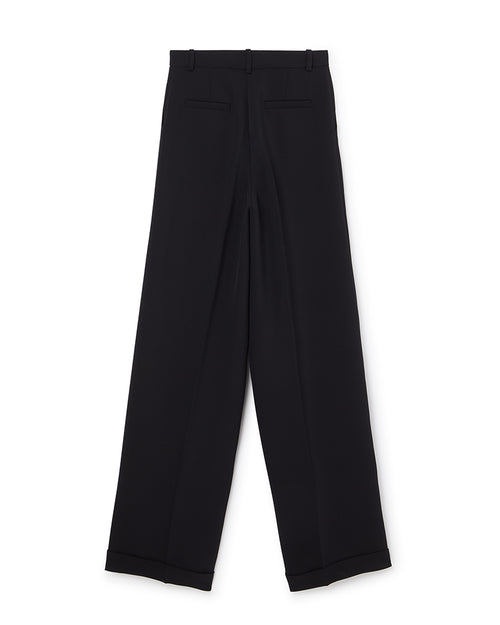 Wide-leg black tailored trousers with crisp pleats and cuffed hems, featuring belt loops and sleek back pockets.