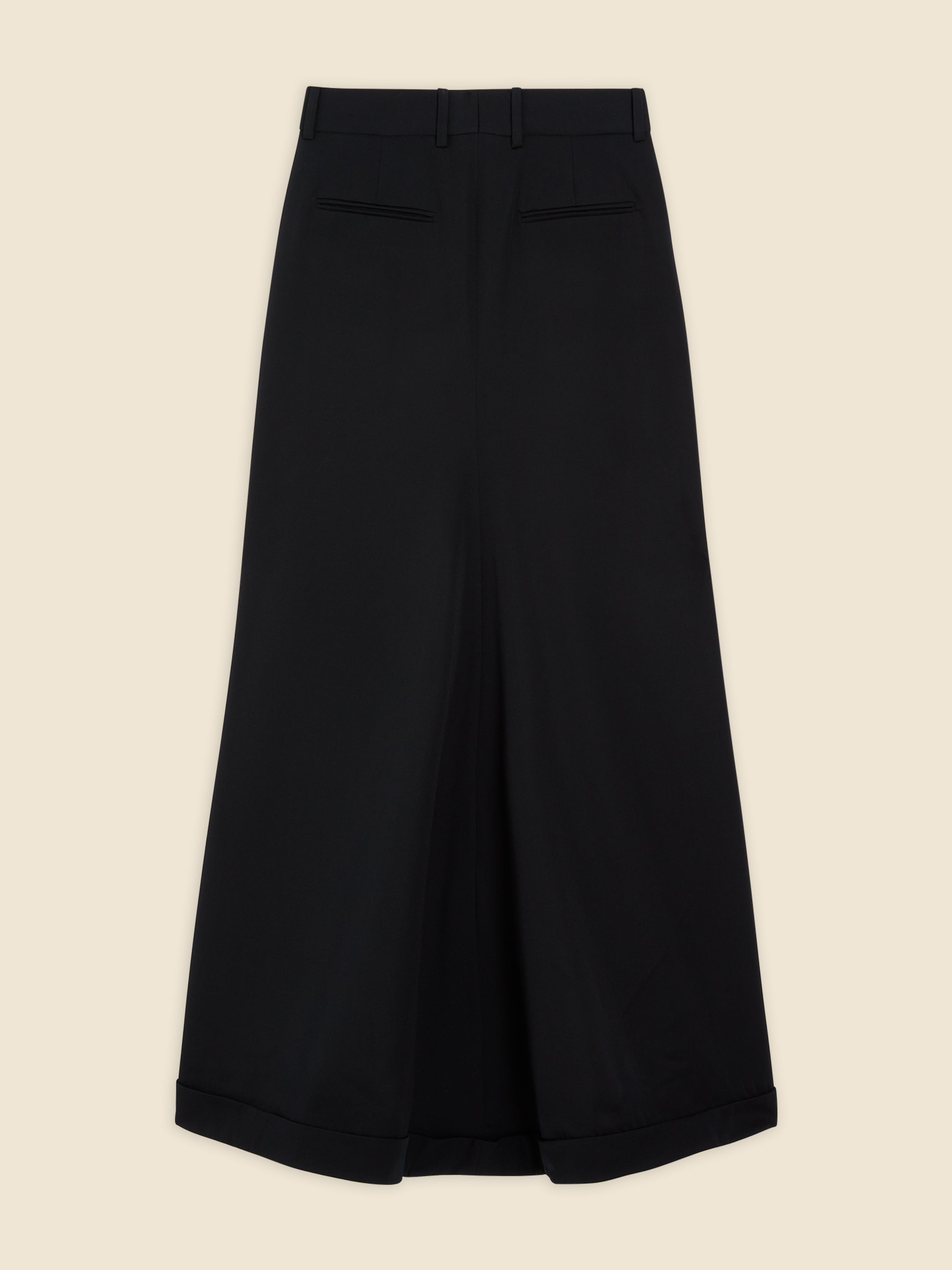Wide-leg black culottes with a tailored fit, featuring neat pleats and subtle cuffed hems, crafted from smooth wool fabric.