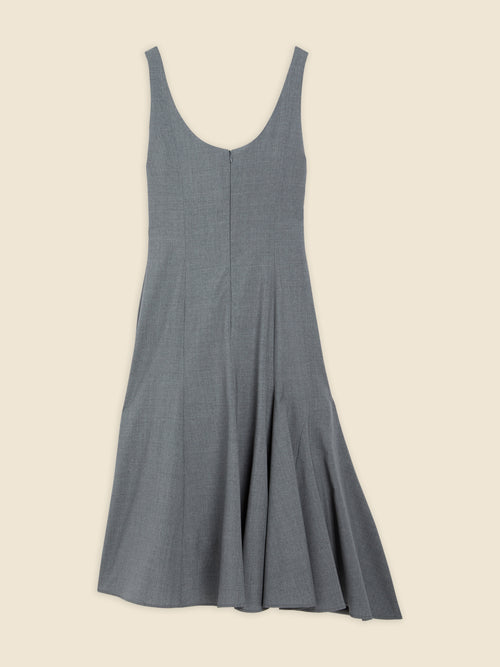 Gray sleeveless dress with elegant pleated hem, featuring a subtle texture and classic zip closure on a neutral background.