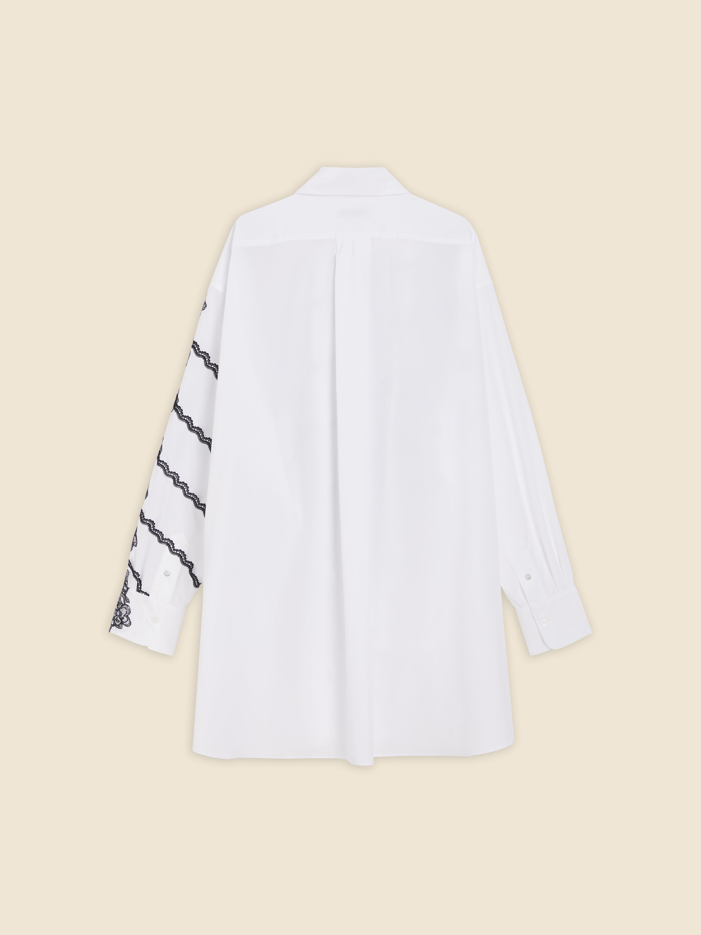 White shirt with black lace embroidery on one sleeve, featuring a crisp collar and buttoned cuffs against a plain background.