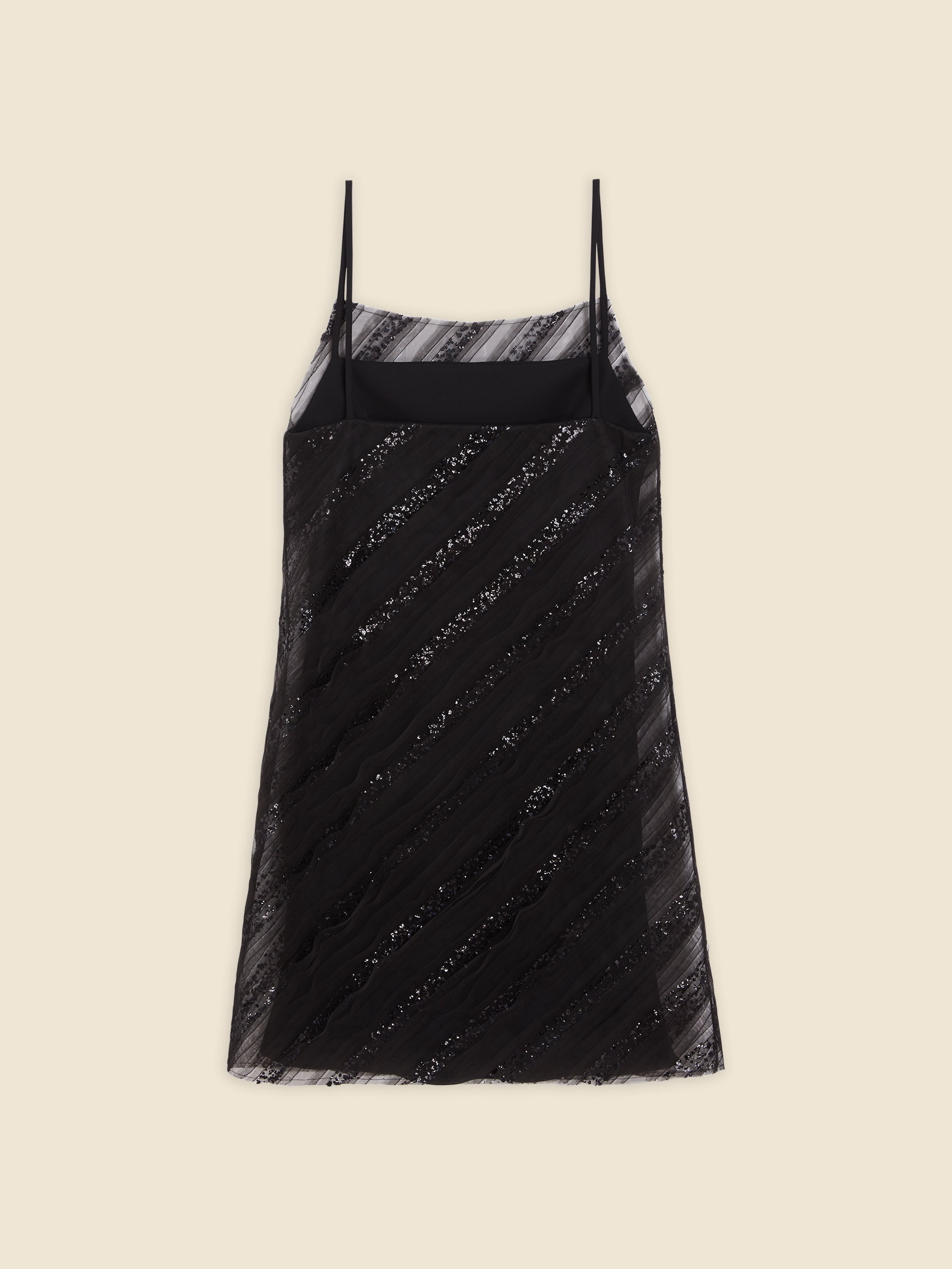 Elegant black slip dress with thin spaghetti straps, featuring diagonal lace detailing and sheer overlay on a neutral background.
