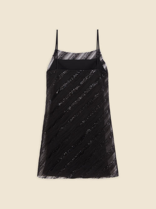 Elegant black slip dress with thin spaghetti straps, featuring diagonal lace detailing and sheer overlay on a neutral background.
