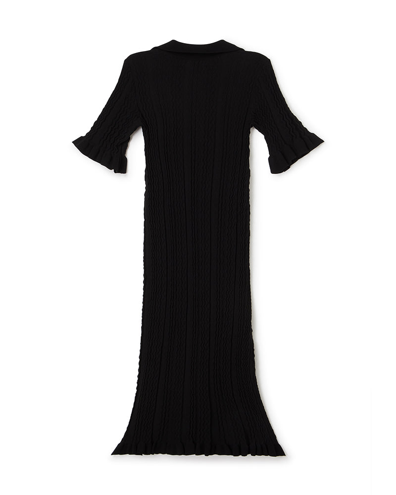 Black ribbed long-sleeve dress with ruffled cuffs and hem, featuring a textured wave pattern for a sophisticated look.