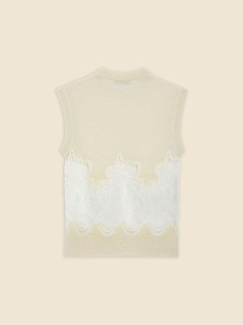 Sleeveless top in soft beige wool with intricate white lace detailing, offering a delicate and elegant design touch.