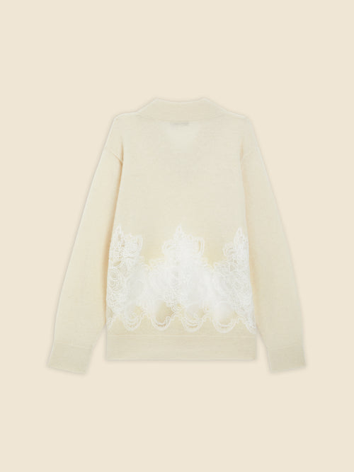 Cream sweater featuring intricate white lace embroidery along the back, adding elegance to the soft woolen texture.