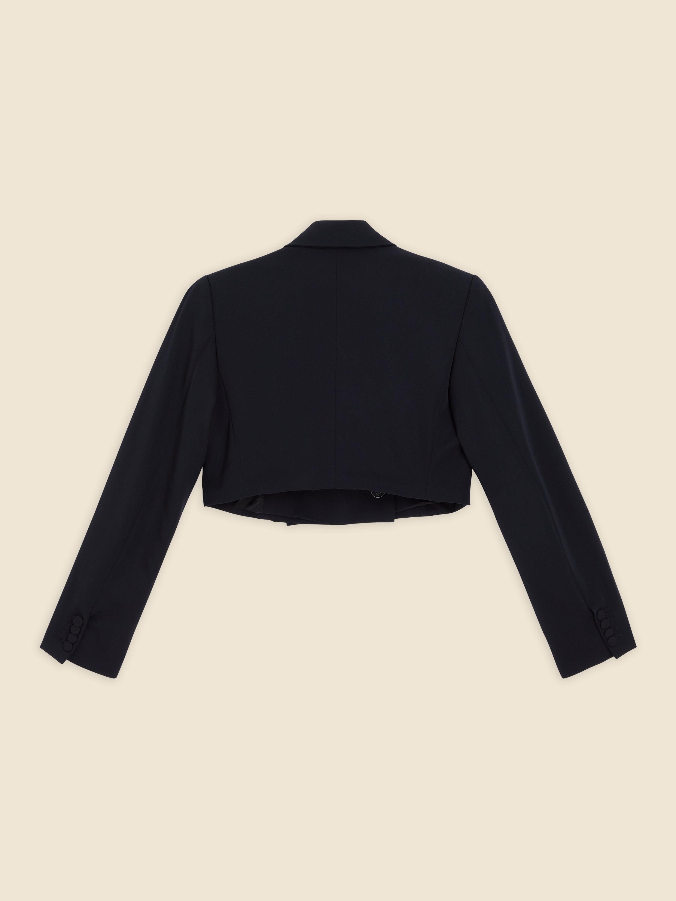 Elegant black wool cropped blazer with tailored long sleeves and button accents on cuffs, designed for a sleek, modern silhouette.