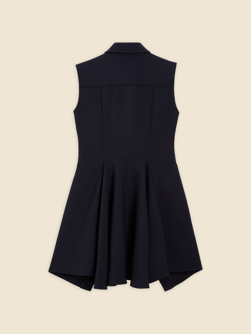 Sleeveless black dress with sharp collar and elegantly flared asymmetric hem on a neutral background, highlighting modern style.