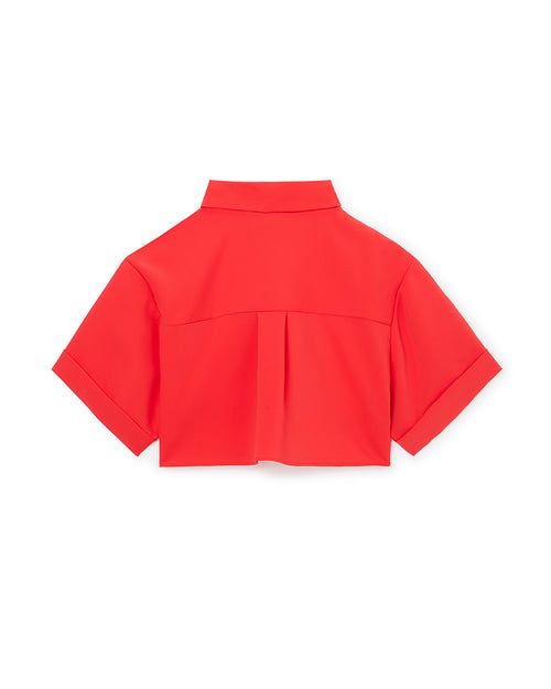 Bright red short-sleeve blouse featuring a box pleat detail on the back and a classic spread collar, made from smooth fabric.