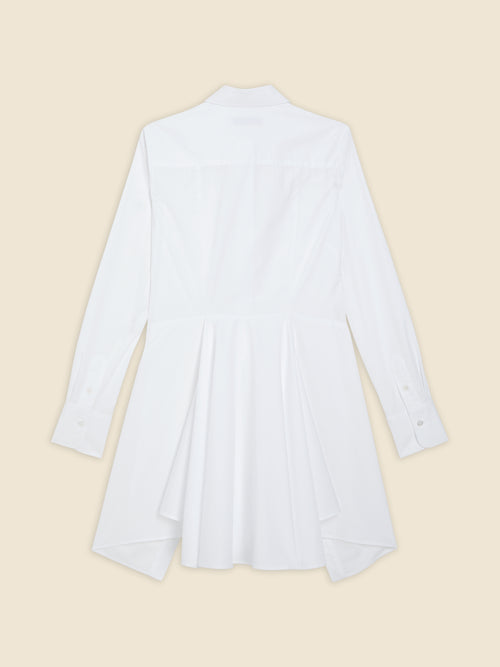 Back view of a flowy white cotton shirt dress featuring long sleeves, classic collar, and elegant pleats enhancing its design.