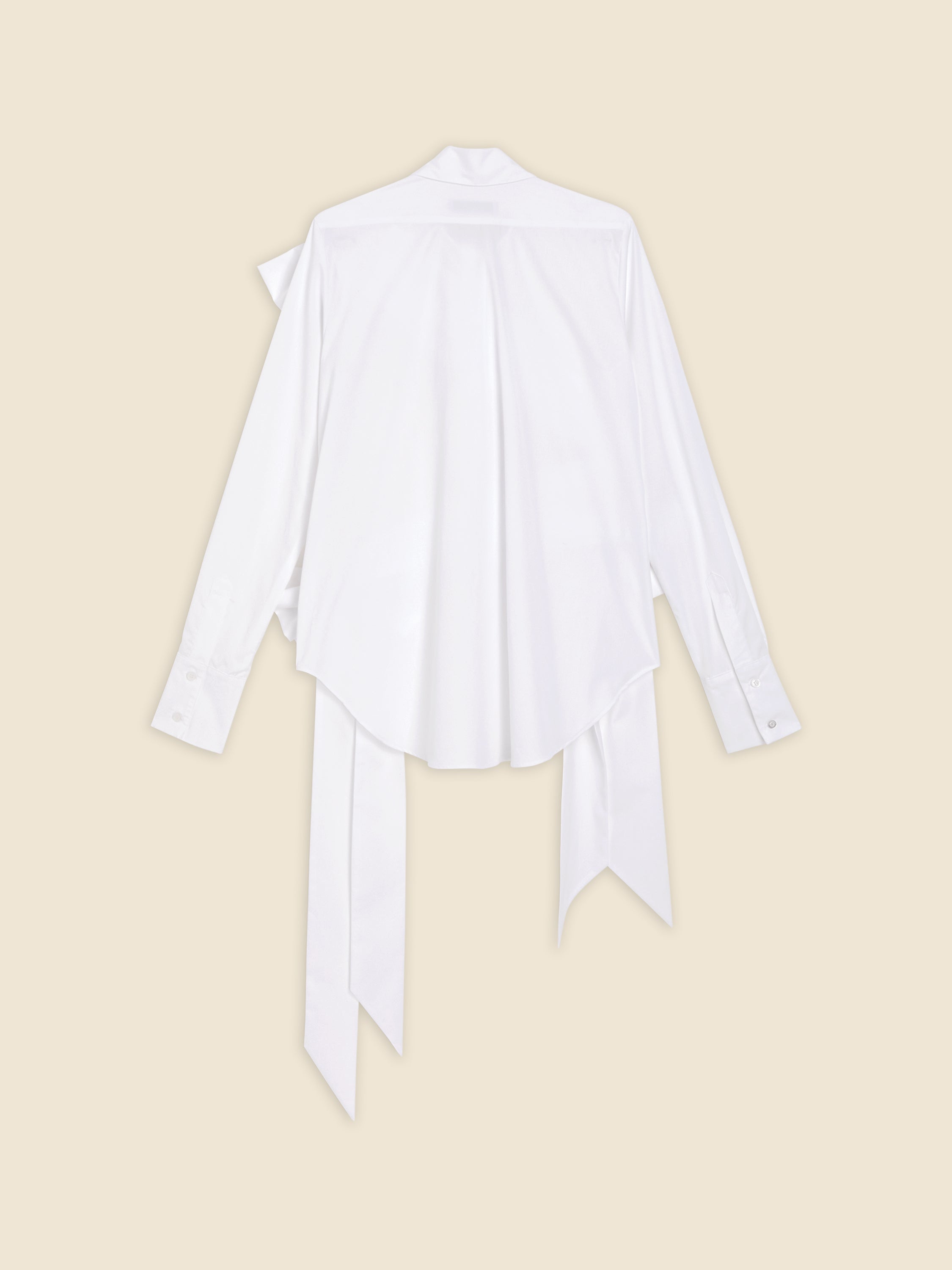 Back view of a white satin blouse with long flowing ties, buttoned cuffs, and a loose fit on a soft beige background.