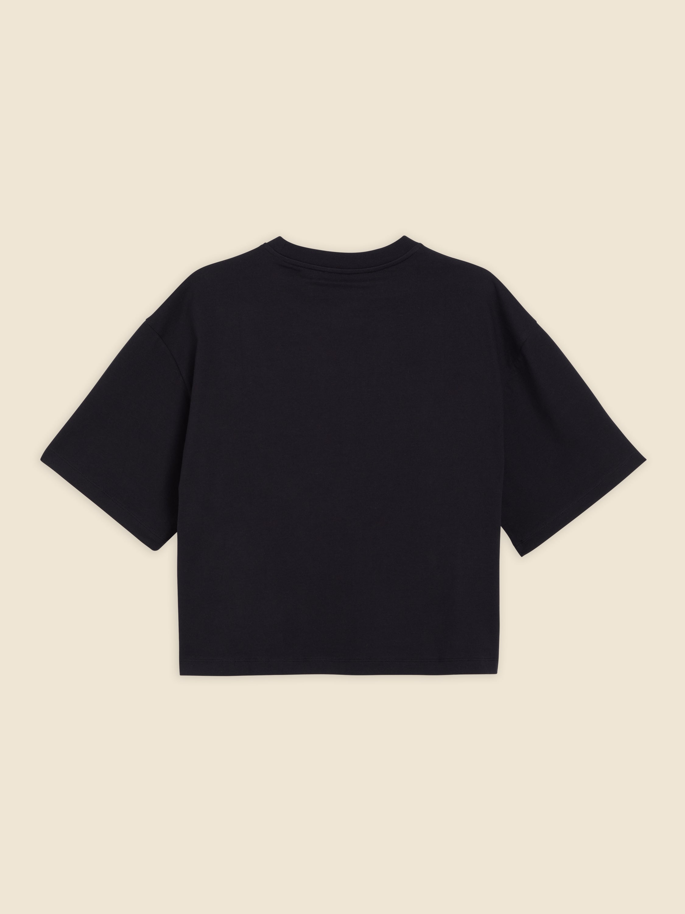 Black cotton oversized T-shirt with a minimalist design and short sleeves, offering a relaxed and contemporary fit.