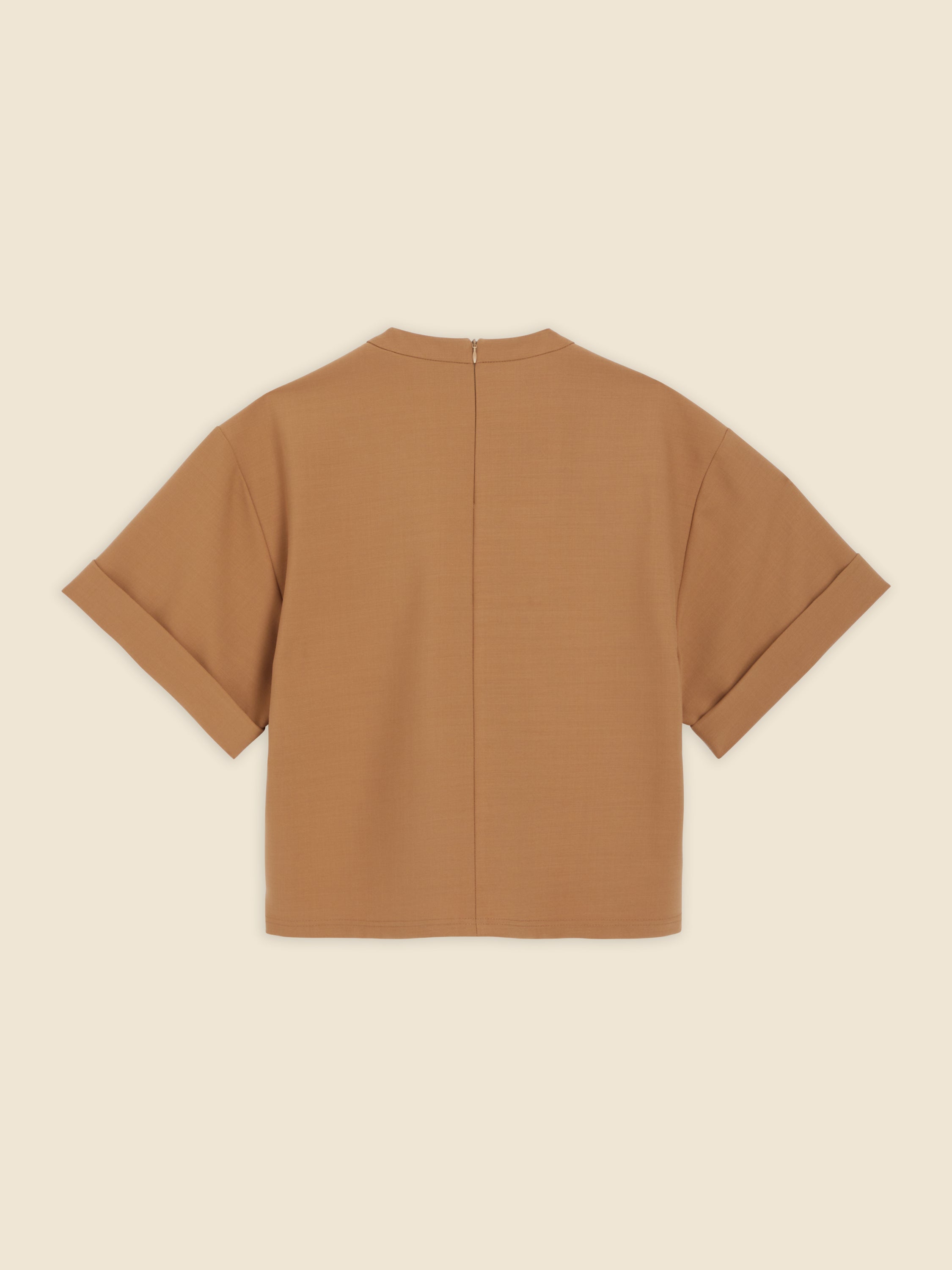 Rear view of camel brown short-sleeve jacket featuring a clean seam and a concealed zipper closure on a minimalist design.