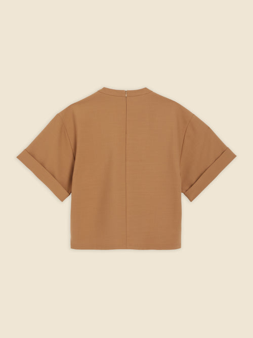 Rear view of camel brown short-sleeve jacket featuring a clean seam and a concealed zipper closure on a minimalist design.