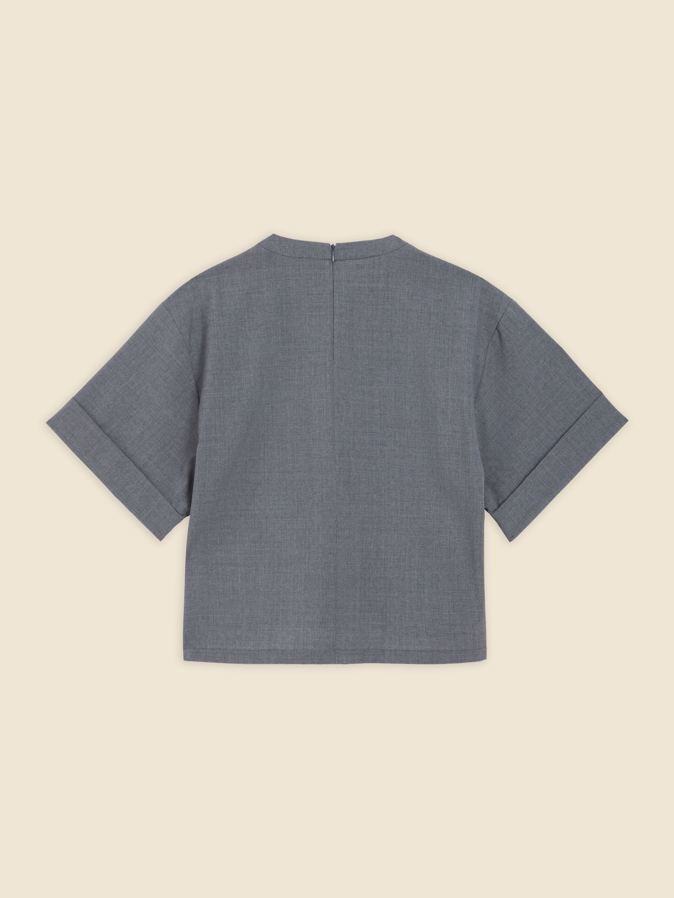 Elegant short-sleeve blouse in textured gray fabric featuring a subtle back zipper and minimalist design.