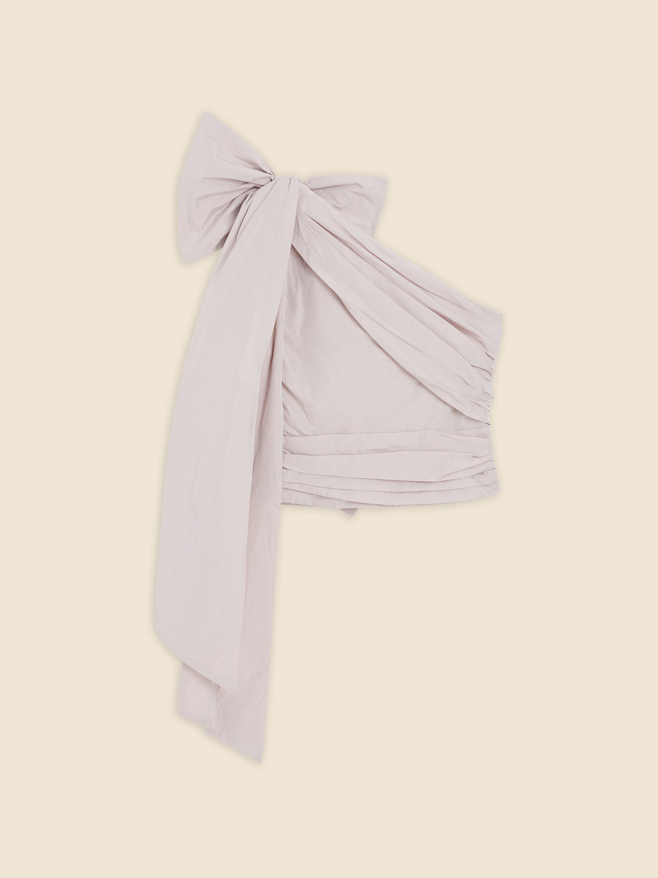 Large pale pink bow with draped fabric, elegantly tied and displayed against a neutral background.