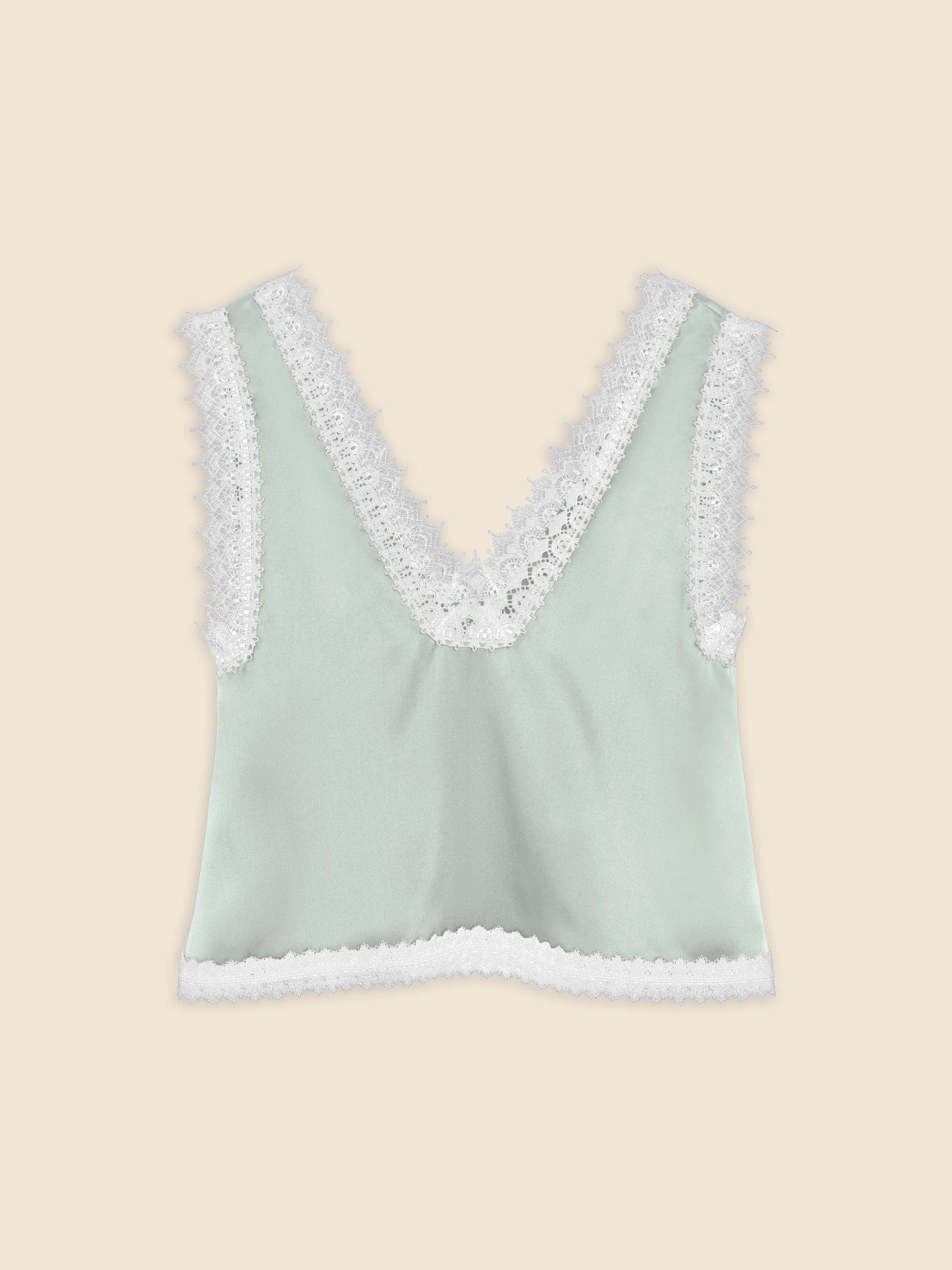 Sleeveless mint green satin top with intricate white lace trim on deep V-neck and hem, offering a delicate and elegant design.