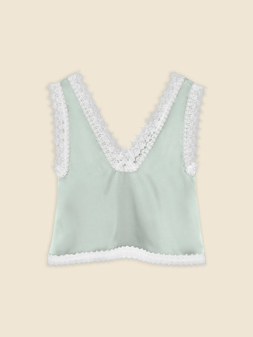 Sleeveless mint green satin top with intricate white lace trim on deep V-neck and hem, offering a delicate and elegant design.