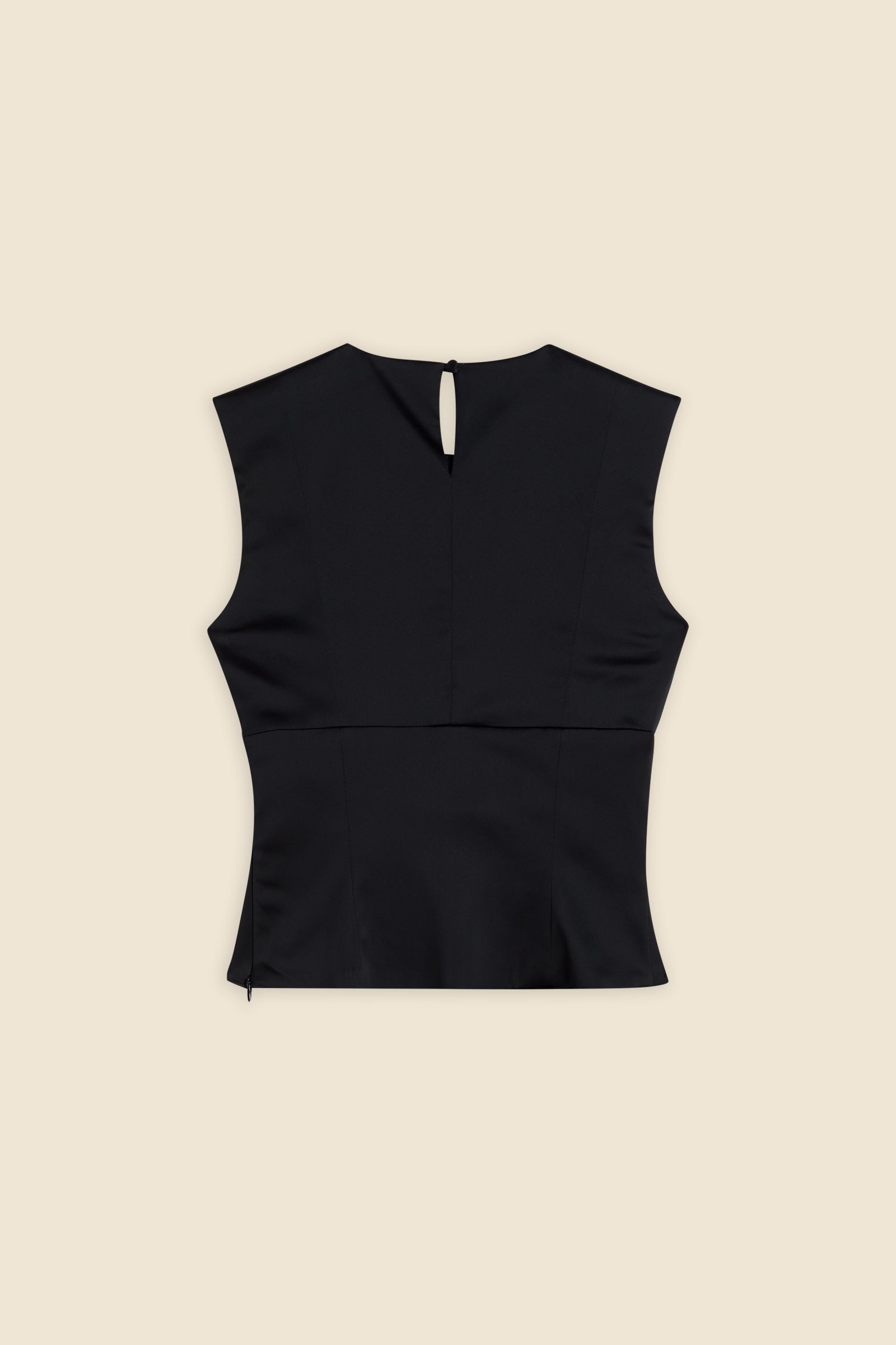 The meticulously placed pleats and stretch satin define the elegance of the top, reflecting classic haute couture craftsmanship with a modern edge